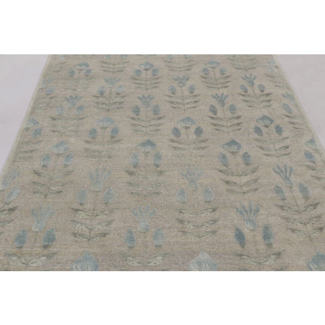 Hand-knotted in a luxurious blend of wool and silk, this 6x8 rug is a serene and sophisticated addition to the Block Print...