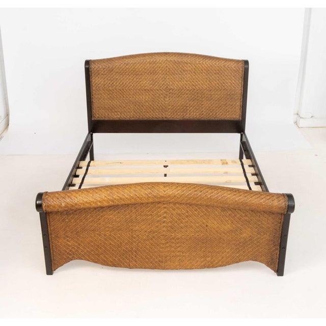 Ebonized Wood and Woven Rattan Queen Sized Sleigh Bed, scrolled headboard and foot. 43" H x 93" L x 63" W. Provenance:...