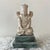Metropolitan Museum Studios reproduction of a seated Buddha, resting atop a green marbled stand. Perfect for adding a...