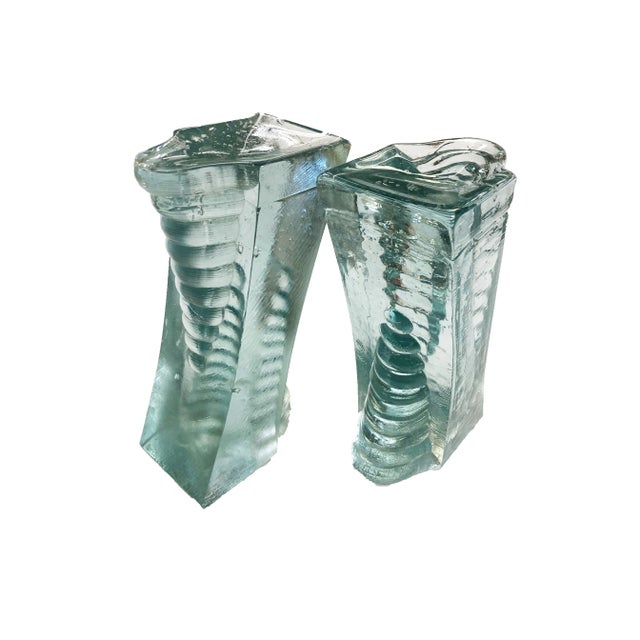 Made of heavy recycled glass, this unique pair of bookends will add a deco futurist vibe to your shelves. Minor chips can...