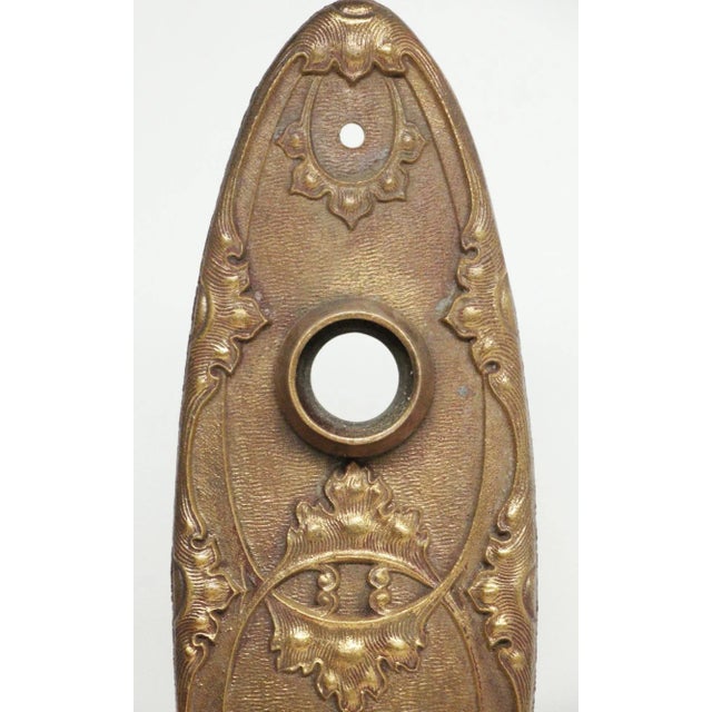 Louis XIV style bronze oval passage door back plates with a delicate floral motif and keyhole. Inscribed 6931 Louis XIII....
