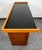Custom black formica and white oak bar with shelving and cabinet below. Unknown maker. The 3 doors below the main surface...