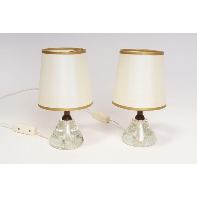 Pair of petite vintage art glass table lamps (ca. 1950, Italy). Composed of conical blown glass bases showing a smattering...