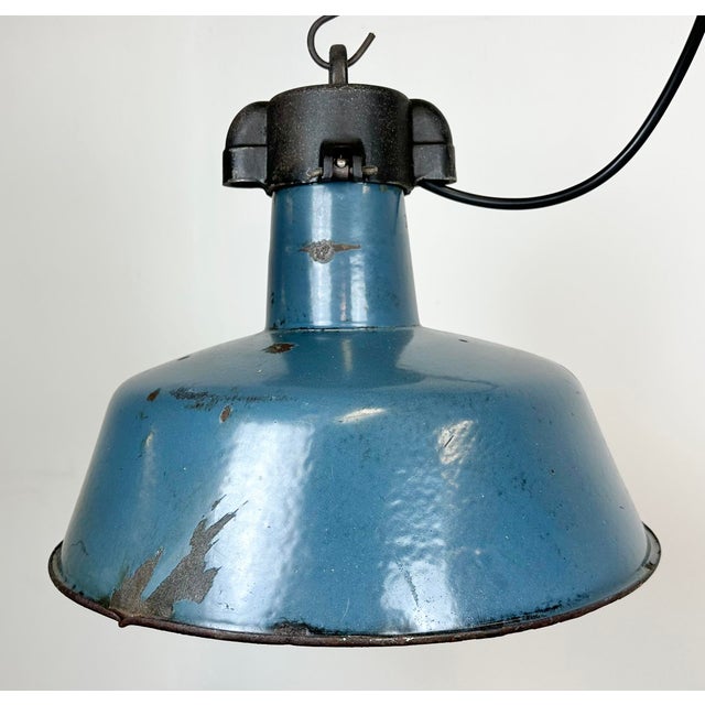 Industrial blue enamel pendant light made by Polam Wilkasy in Poland during the 1960s. White enamel inside the shade. Cast...