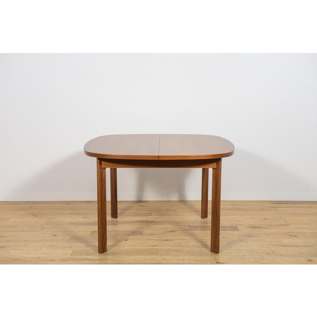 This extending dining table was manufactured by the renowned British furniture maker G-Plan during the 1960s. The piece...