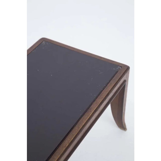 Low coffee table attributed to Gio Ponti, designed in the 1950s. The low table has a perfectly intact dark glass top. The...