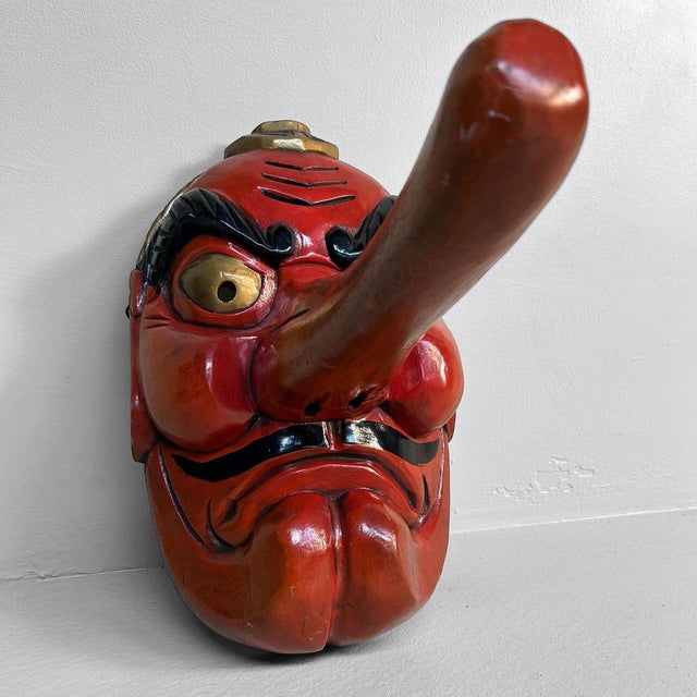 Authentic hand-carved Tengu mask from Japan, dating back to the 1950s. Crafted from wood and painted in vibrant red,...