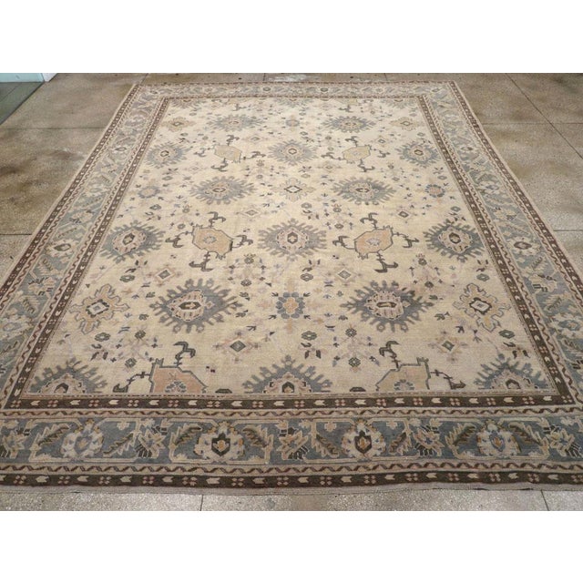 A wool pile with symmetric knots on a cotton foundation. This elegant workshop carpet showcases a cream field with a...