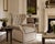 An upholstered wingback armchair featuring a deep button-tufted backrest, rolled arms, and a skirted swivel base. The...