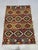 This Afghan Chobi wool kilim features a colorful Khorjin saddlebag-inspired design with repeating geometric diamond motifs...