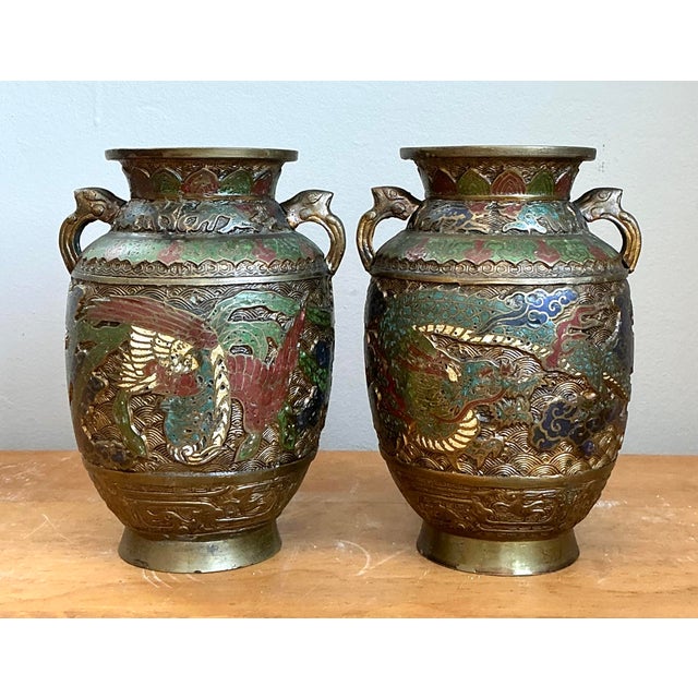 This exquisite pair of vintage Asian urns showcases the timeless artistry of cloisonné enamel on a heavy brass ground....