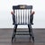 This elegant black Windsor chair features gold detailing and a unique gold emblem on the backrest. The arms are finished...
