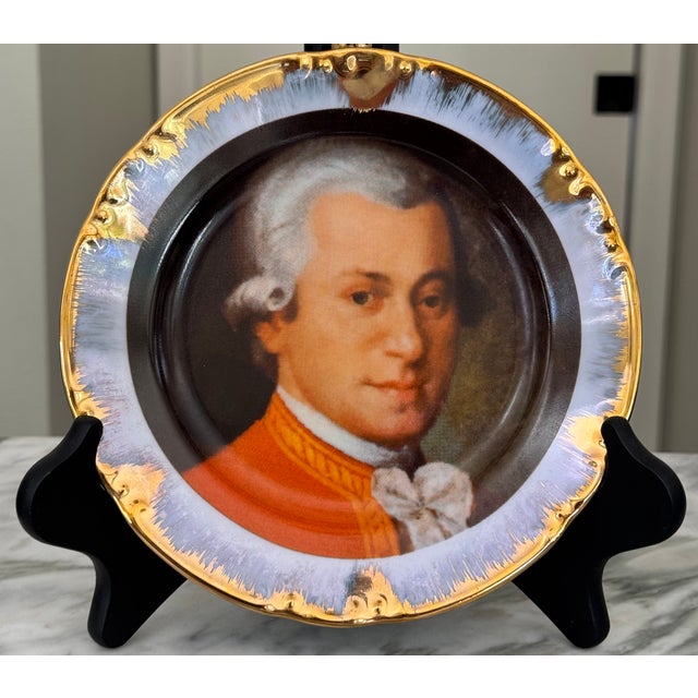 Presenting a stunning image of the famous composer Wolfgang Amadeus Mozart (1756-1791) on a decorative gilt plate. It's a...