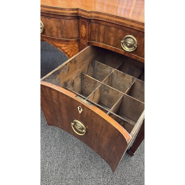 An exceptional American Federal mahogany sideboard dating to the late 18th or early 19th century, circa 1790–1810....