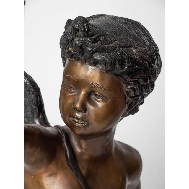 Pair of Cupids carrying a torch. The statues are heavy and detailed. The lampshades are handmade from frosted etched...