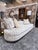 An exceptional Tomlinson Cambria sofa by Theodore Alexander showcasing a fluid curved silhouette with a refined...
