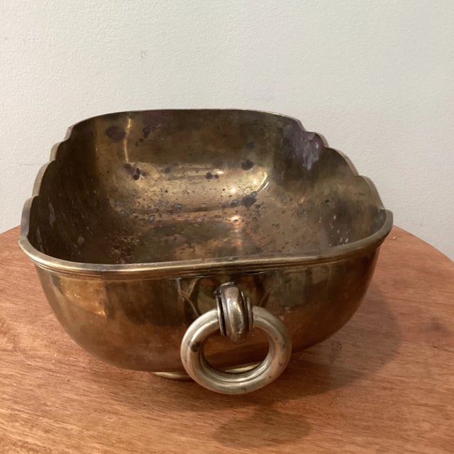 A heavy solid brass Mid Century Modern cachepot or planter. This piece is oval in shape and has scalloped edges encircling...