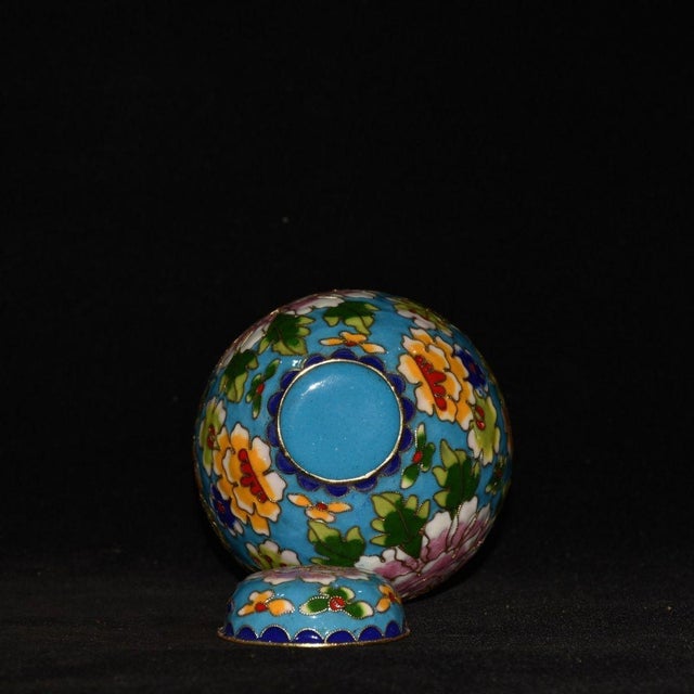 Add a touch of vibrant elegance to your home decor with this exquisite cloisonné enamel jar. This charming piece features...