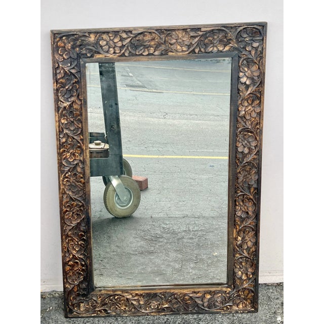 Vintage Carved Wooden frame. The carving features a floral design. Measures 24” x 36”. The mirror has a 4” boarder. This...