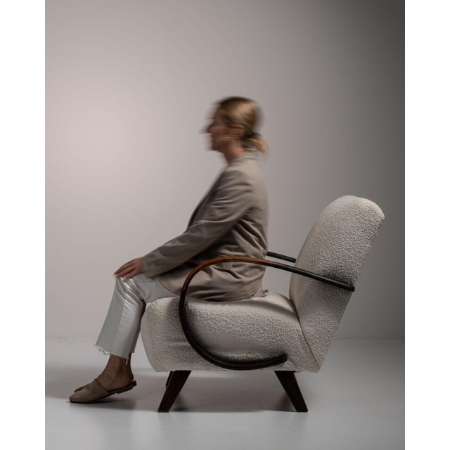 Bentwood-arm lounge chair in Warm Ivory Boucle. Finished in warm ivory boucle, this bentwood-arm lounge chair is...