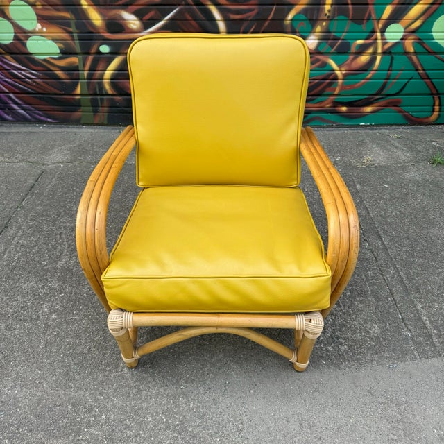 Mid Century Modern Bamboo Arm Lounge Chair. This chair features bamboo base and a yellow or gold faux leather cushion....