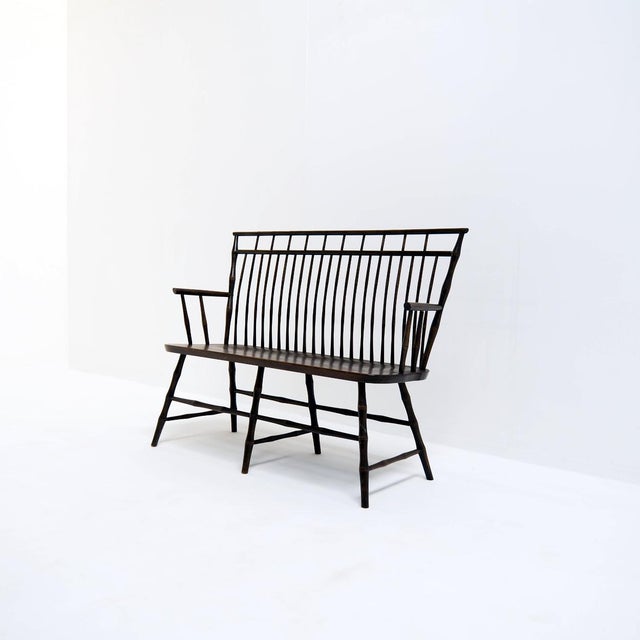 Vintage wooden spindle back settee in faux bamboo. The bench probably dates from the 1960s or 1970s and is in good vintage...