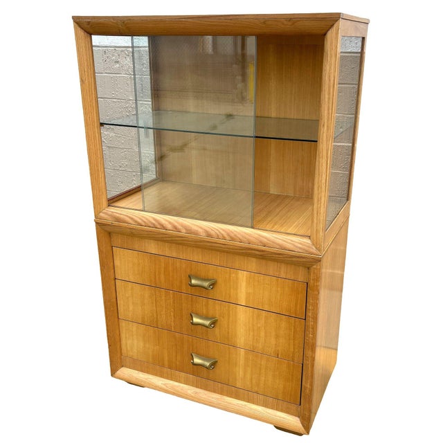 Original Birch curio cabinet and drawers with bronze scrolling drawer pull feature a sleek cubist mid-century design...