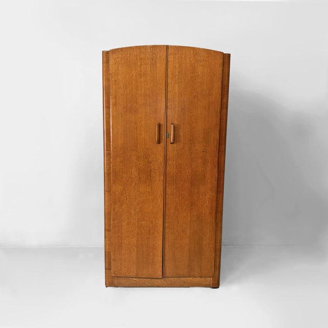 Italian art deco wooden wardrobe with mirror, 1930s Two-door wooden wardrobe featuring a linear structure with rounded...