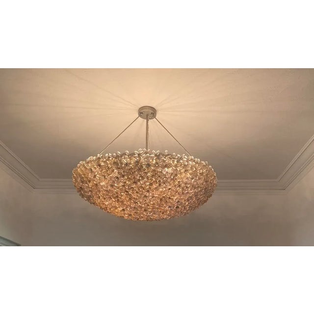 Beautiful clear lucite daisies that are joined together, creating a half-moon bouquet with light passing through it. The...