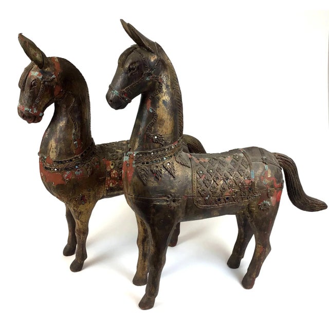 Circa 1800’s Tibet carved wood horses. Embellished with clay sculpture and glass beads over the wood carving. These horses...