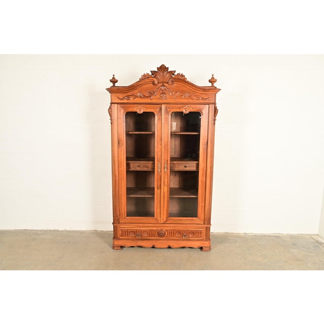 An exceptional antique Victorian or Renaissance Revival bookcase or display cabinet In the manner of R.J. Horner & Co....