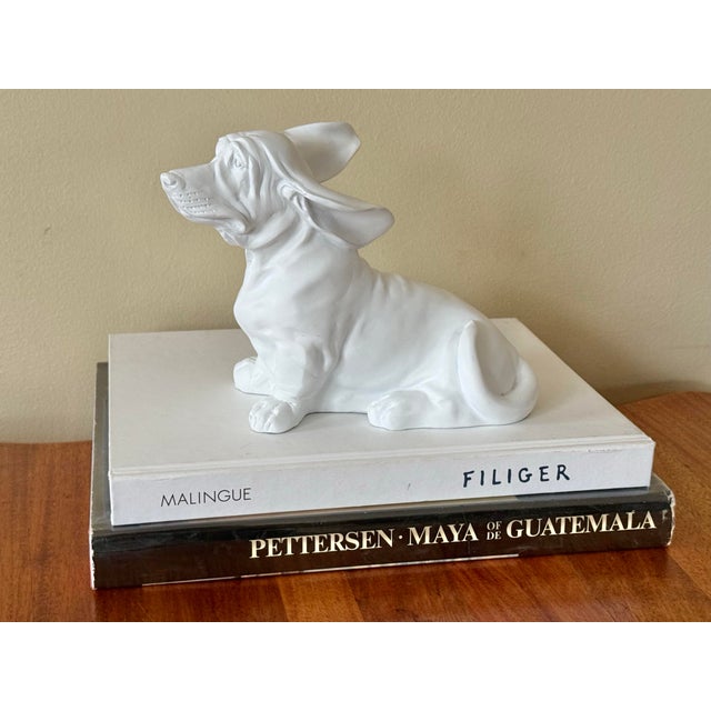 Whimsical matte white basset hound figure with ears blowing in the wind. Crafted in the early 21st century. Most items...