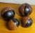 Set of Four Brass Studded Two-tone Leather Clad Wood Decorative Balls Spheres Orbs. Two 4” diameter, and two 3” diameter....