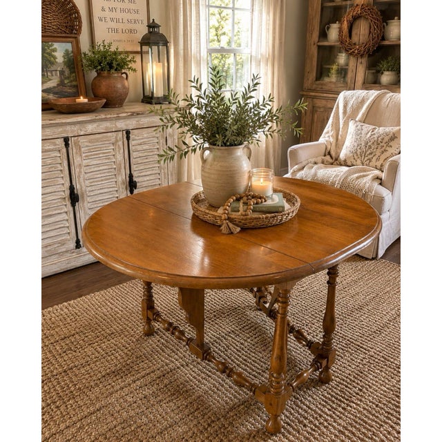 This table has been in the family since its original purchase! Classic vintage Ethan Allen drop-leaf side table crafted in...