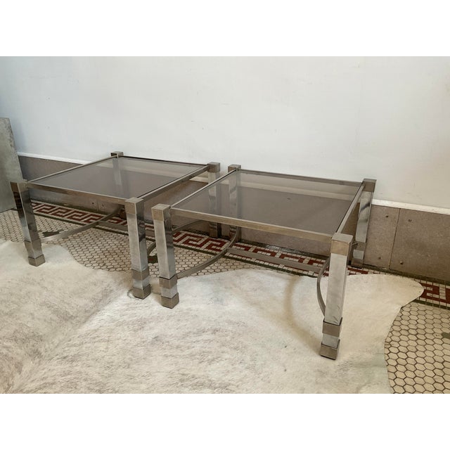 Enhance your space with this striking pair of 1960s French Art Deco style side tables. Featuring metal frames detailed...