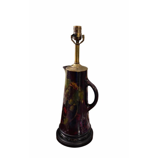 A beautiful vintage Weller pottery table lamp featuring an elegant handled ewer-form ceramic body with a dramatic high-...
