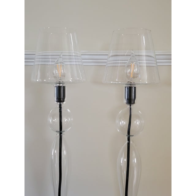 This custom pair of glass lamps are hand blown from a simple glass tube by a master craftsman, making each piece truly...