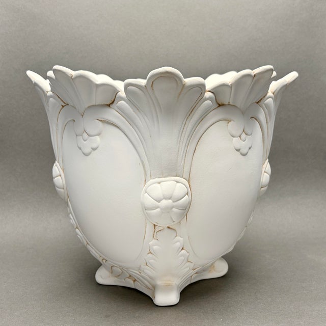 • Unmarked ornate footed jardiniere planter with raised floral, foliate and scrollwork decoration. • Vintage design with...