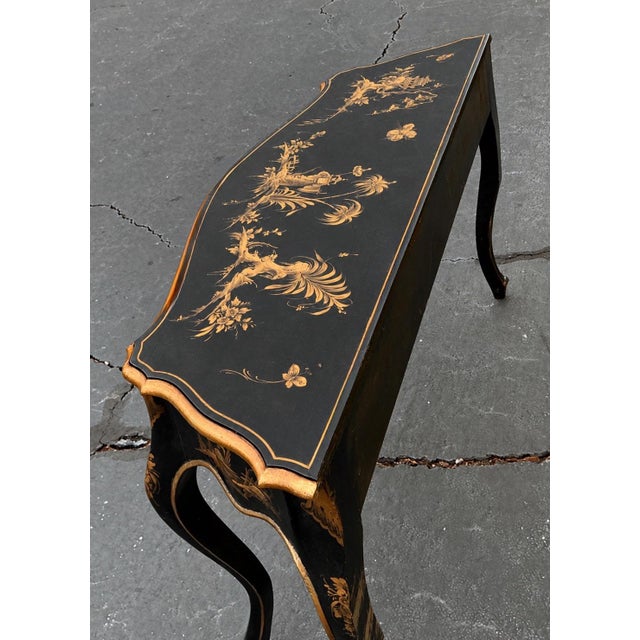 This is a mod-century Italian black and gilt chinoiserie console table. It has a lovely pastoral chinoiserie top, and it...