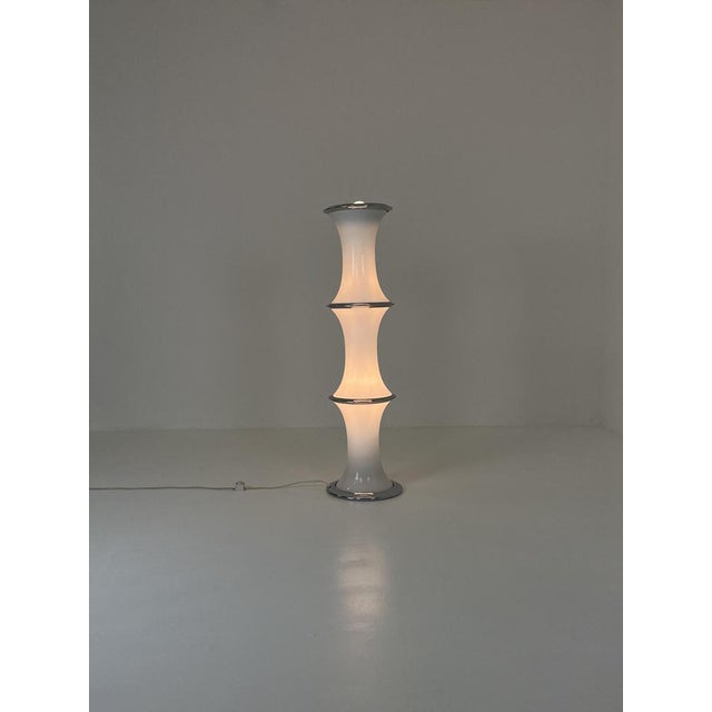 The "Bamboo" floor lamp, designed by Enrico Tronconi in the 1970s for Vistosi, is an emblematic example of Italian space-...