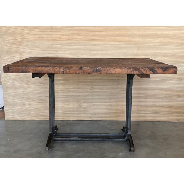Work table with walnut top. Item features impressive cast iron construction, two pedestal legs, fancy scroll work to legs...