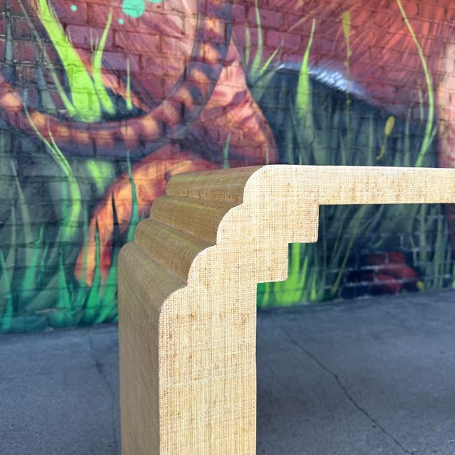 Post Modern Grass Cloth Sofa Console Table. This 80s console table has scalloped edges and is covered in a light wheat...