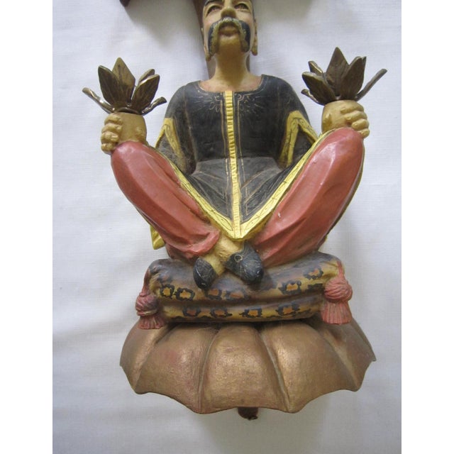 Chinoiserie chalkware wall bracket. Holds two candles and wall mounts with a hanging hook on the back. It measures 22"H x...