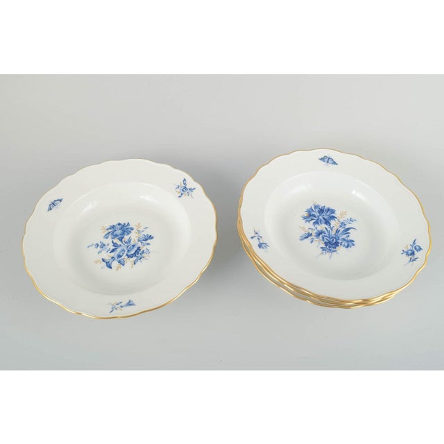 Meissen 4 deep plates, early 20th century. Hand-decorated porcelain with hand-painted blue floral decoration and gilded...