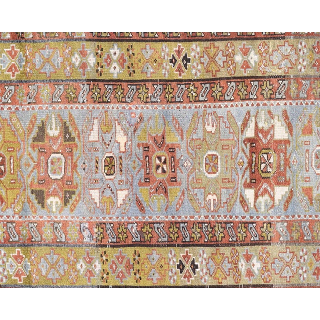This semi-antique Persian Melayer runner, measuring 3'1" x 13', is handwoven in Iran's Hamadan region and has been...