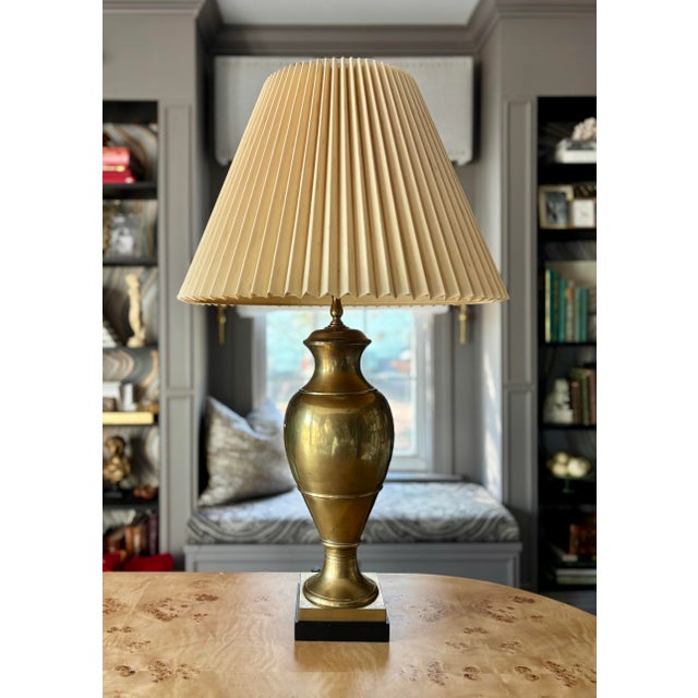 Striking brass urn lamp with wood felted base. Heavy living brass of remarkable craftsmanship and imposing stature at 33...