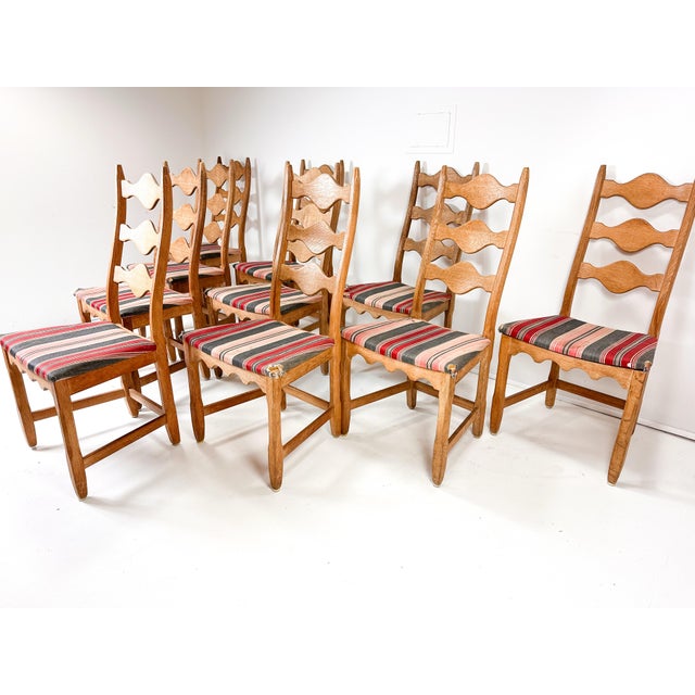 Set of ten dining chairs by Henning Kjaernulf for Nyrup Mobelfabrik. Sculpted solid Oak frames have a warm rustic and...