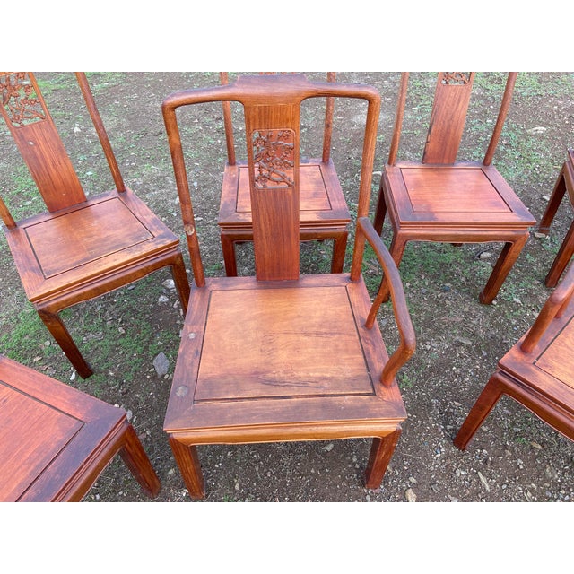 This set of 8 antique carved Chinese rosewood arm chairs, dating back to the early 20th century, is a vintage original...