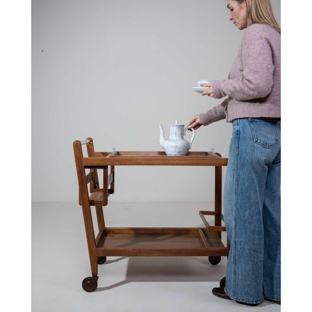 A bar cart whose medium oak, two-tier, castor wheels gives it real character at first glance. The piece dates to 1960s,...