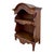 Charming Spanish open shelf crafted from wood, featuring an elegant curved top and beautifully carved floral decorations....